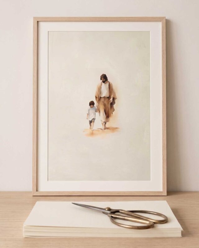 Jesus walking hand in hand with a child, printable Christian wall art shown framed beside a stack of blank print paper
